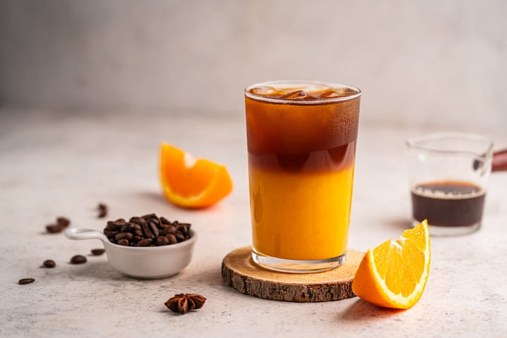 Coffee with orange juice (bumble) in a tall glass with ice