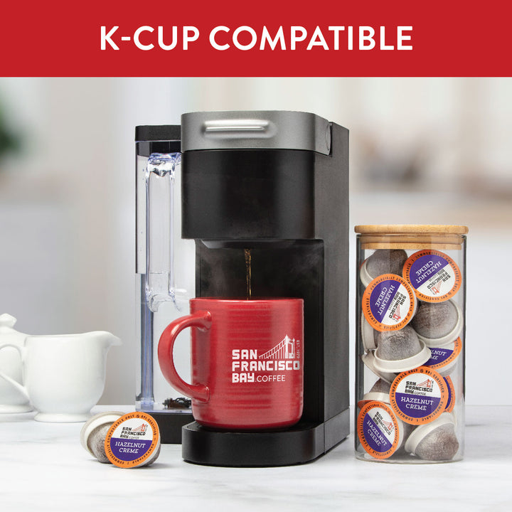 K-Cup compatible. Image of K-Cup brewer with SF Bay Coffee products.